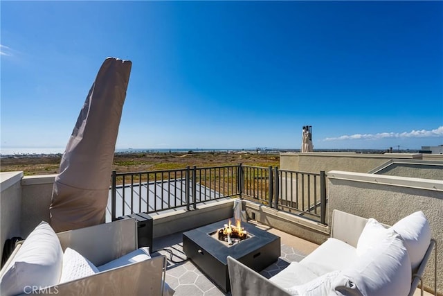 exterior space with a balcony and an outdoor living space with a fire pit