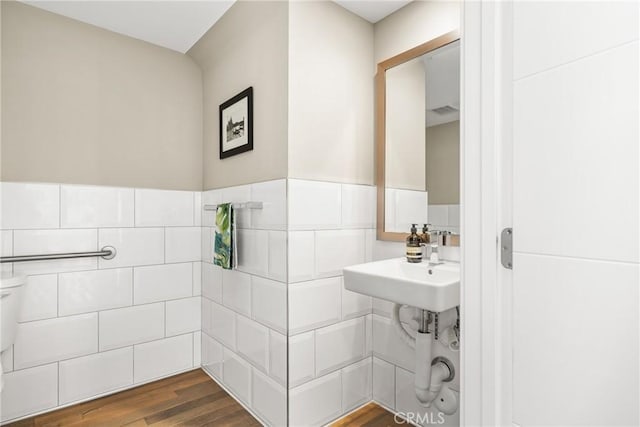 bathroom with hardwood / wood-style floors and toilet