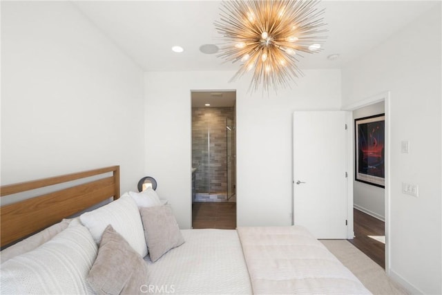 bedroom featuring connected bathroom, light hardwood / wood-style flooring, and a notable chandelier