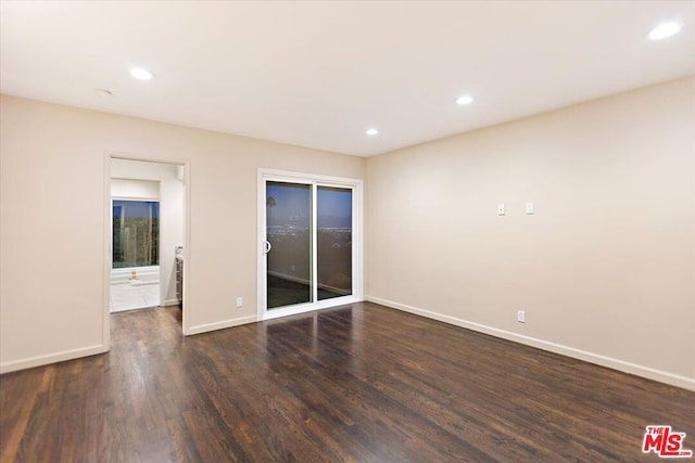 unfurnished room with dark hardwood / wood-style floors