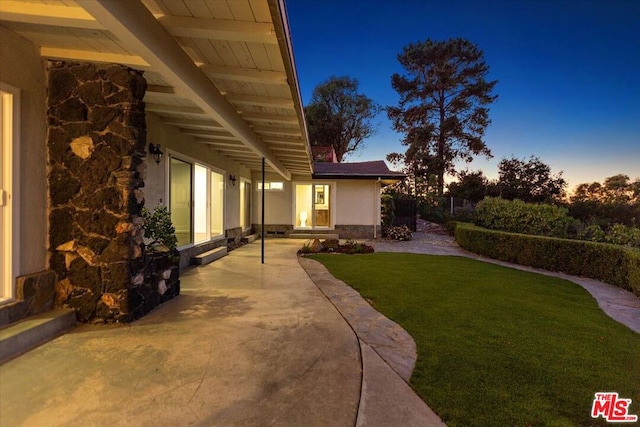 yard at dusk with a patio