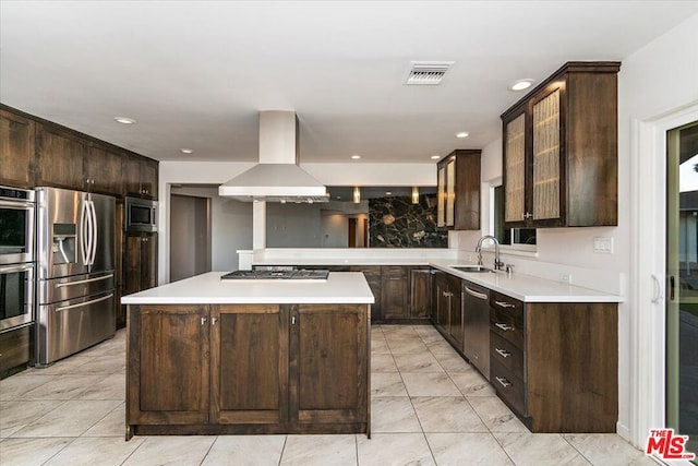 kitchen with appliances with stainless steel finishes, a center island, dark brown cabinetry, and exhaust hood