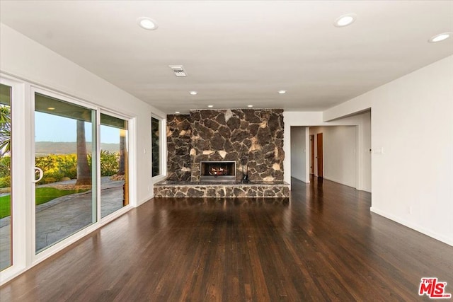 unfurnished living room featuring dark hardwood / wood-style flooring and a fireplace