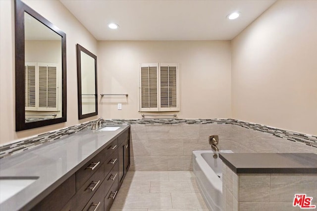 bathroom with a tub to relax in, tile patterned floors, radiator, vanity, and tile walls