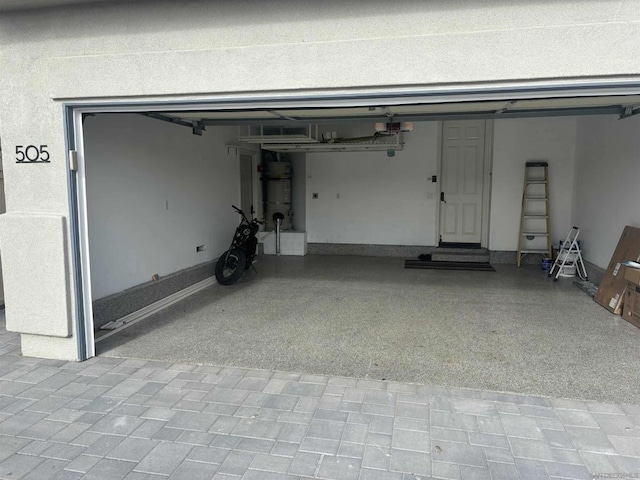 garage with a garage door opener and water heater