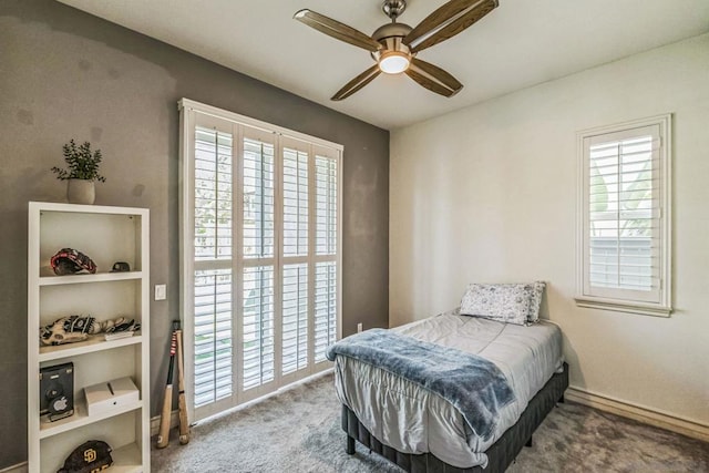 bedroom featuring multiple windows, ceiling fan, and carpet