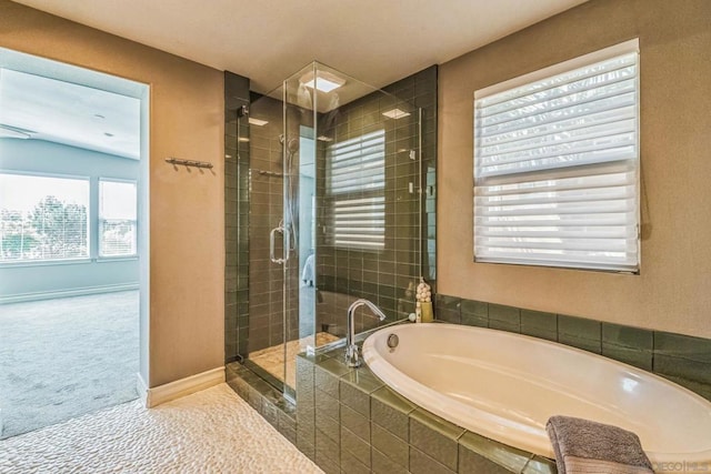 bathroom featuring plus walk in shower, lofted ceiling, and a healthy amount of sunlight