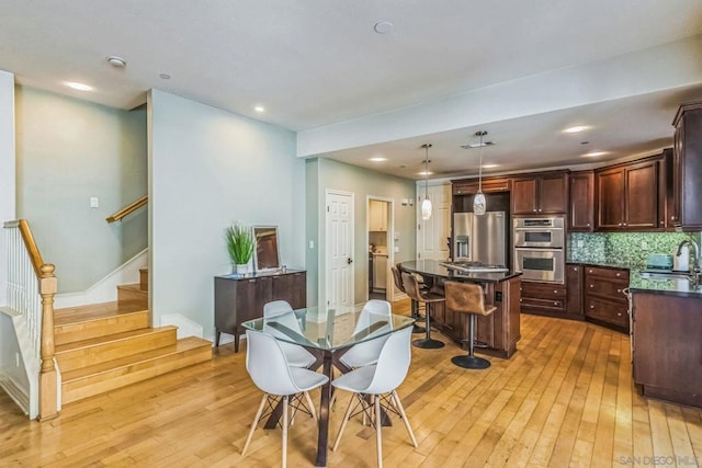 dining room featuring light hardwood / wood-style flooring and sink