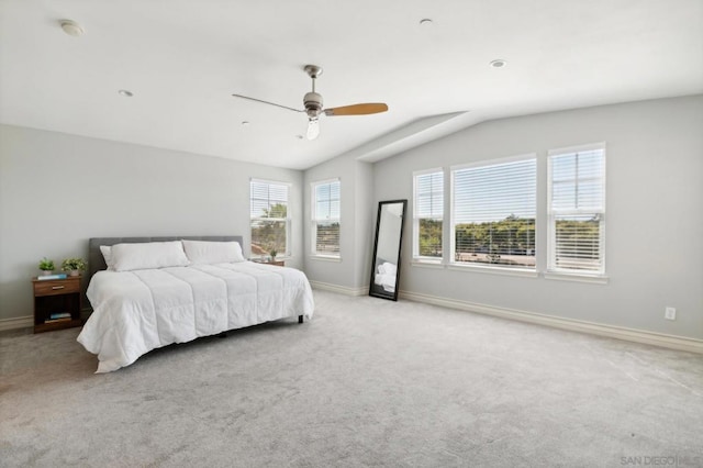 bedroom with ceiling fan, light colored carpet, and lofted ceiling