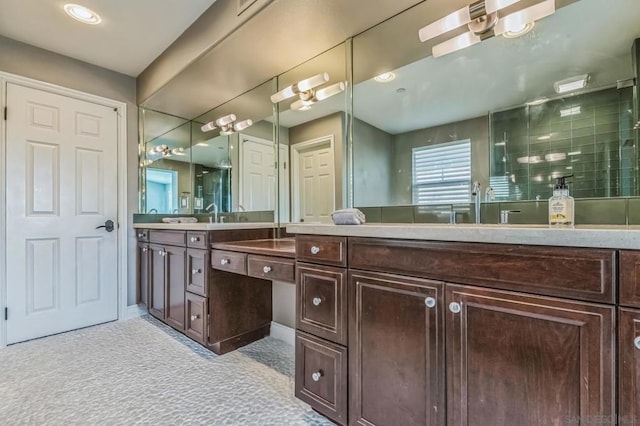 bathroom featuring a shower and vanity