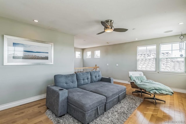 living room with ceiling fan and wood-type flooring