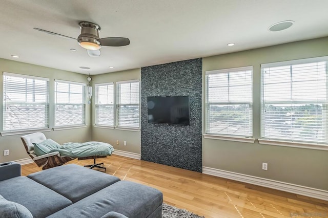 living room featuring hardwood / wood-style floors, ceiling fan, and a healthy amount of sunlight