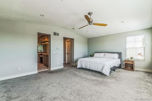 bedroom with carpet floors, ensuite bath, ceiling fan, and lofted ceiling