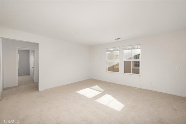 spare room featuring light colored carpet