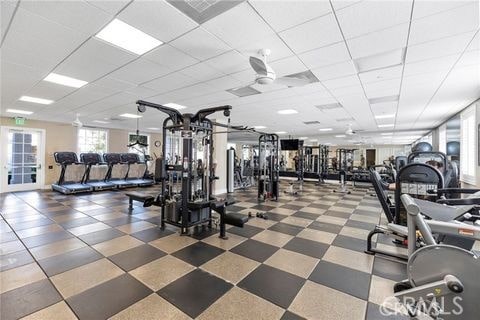 workout area featuring a paneled ceiling and ceiling fan