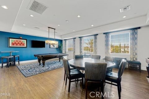 dining space featuring wood-type flooring and billiards