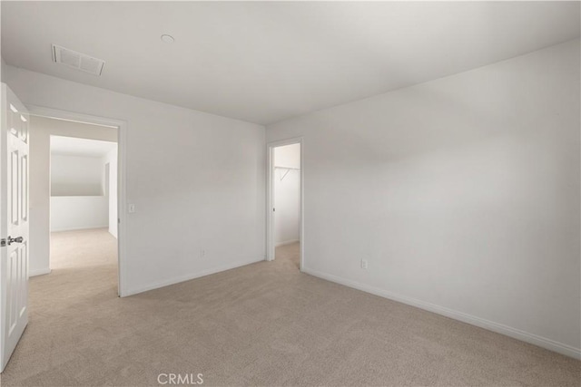 unfurnished room featuring light carpet