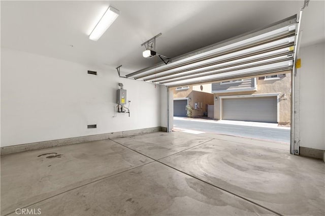 garage featuring a garage door opener and water heater