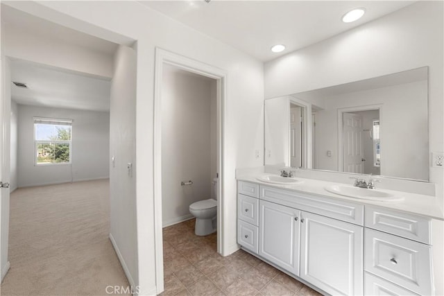 bathroom featuring vanity and toilet