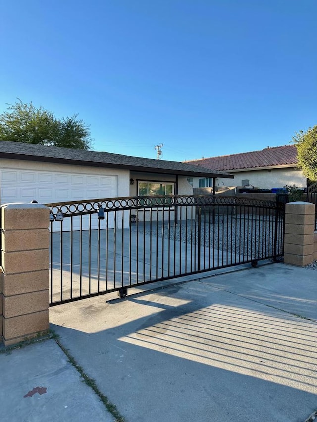 view of gate featuring a garage