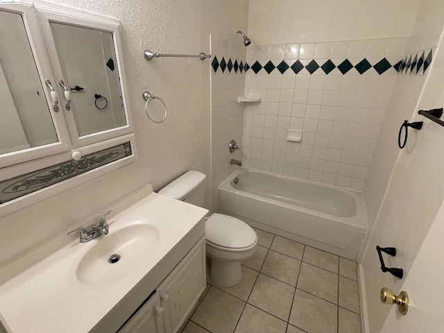 full bathroom with tile patterned floors, vanity, toilet, and tiled shower / bath