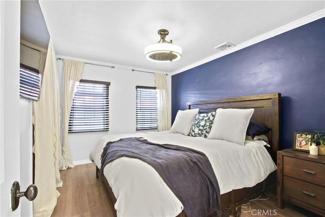 bedroom featuring dark hardwood / wood-style flooring and ornamental molding