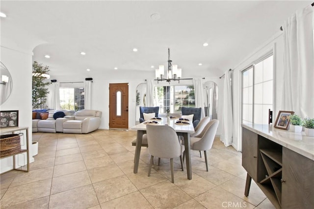 dining room featuring a chandelier, a wealth of natural light, and light tile patterned flooring