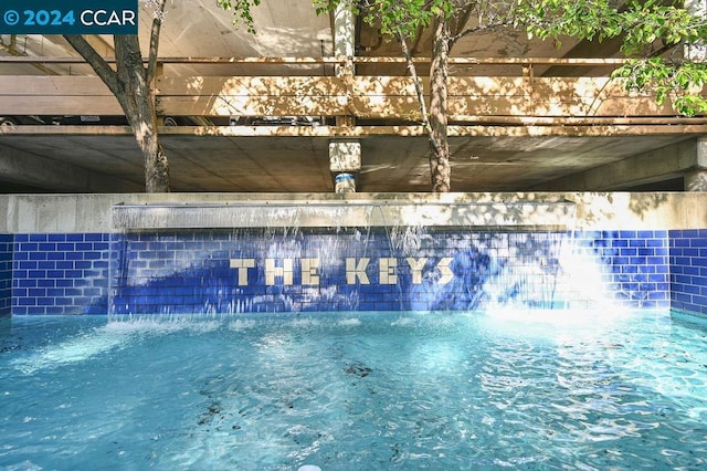 view of swimming pool featuring pool water feature