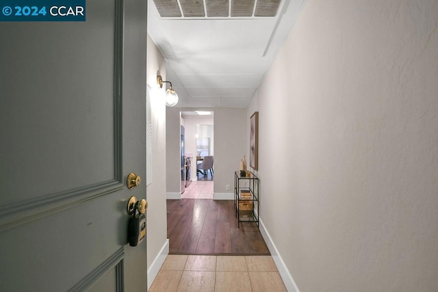 corridor with hardwood / wood-style flooring