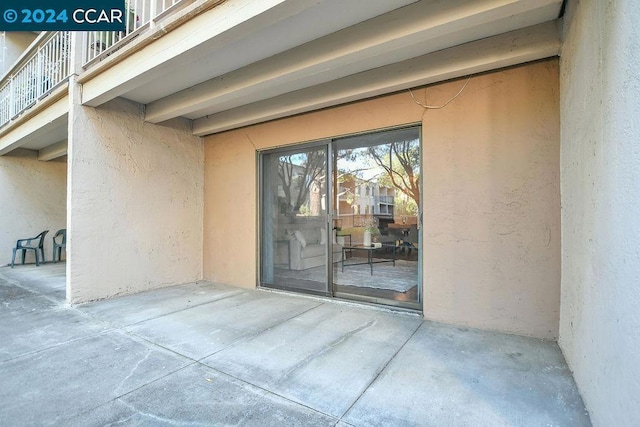 entrance to property with a balcony and a patio area