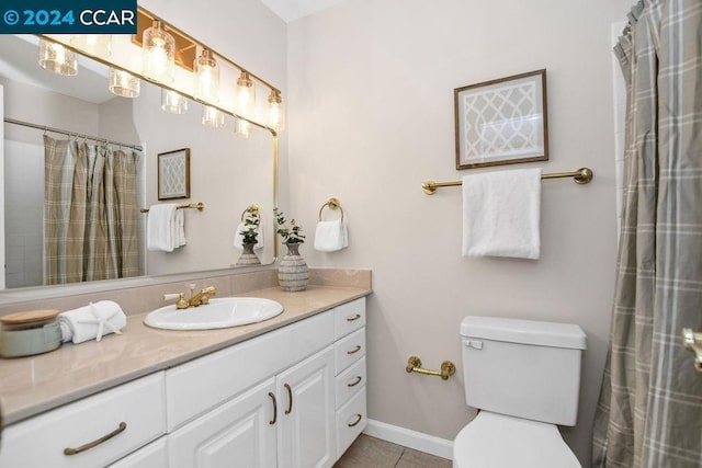 bathroom with tile patterned floors, vanity, and toilet