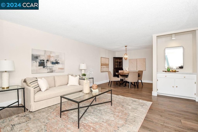 living room featuring a textured ceiling and hardwood / wood-style flooring