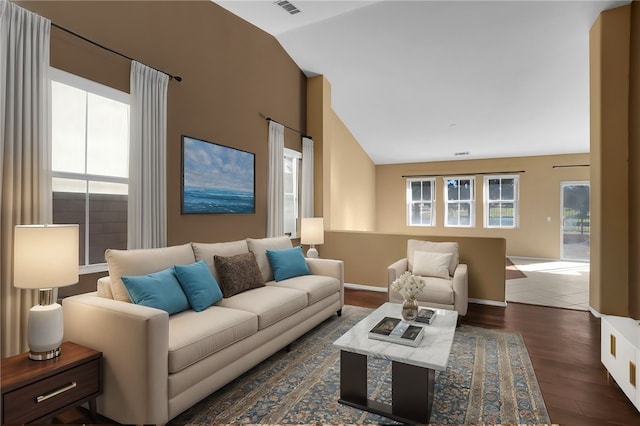 living room with dark hardwood / wood-style flooring and vaulted ceiling