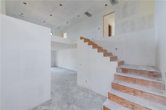 staircase with a high ceiling