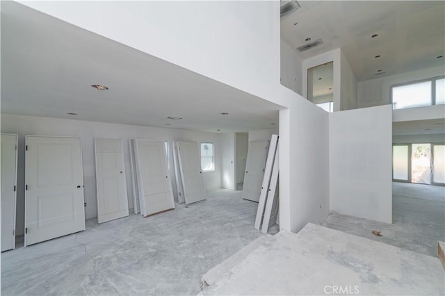 interior space featuring a high ceiling and a wealth of natural light