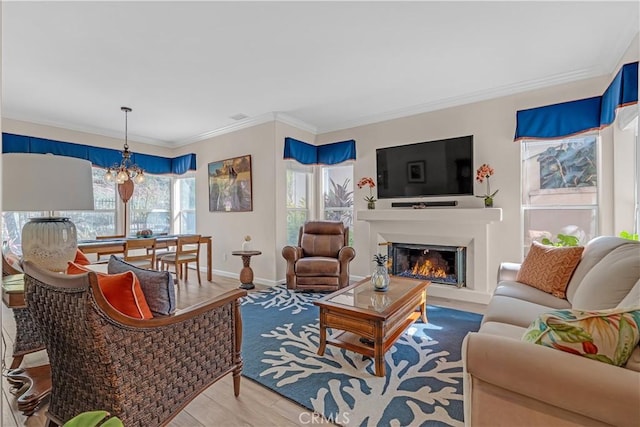 living room with crown molding, a notable chandelier, and hardwood / wood-style flooring