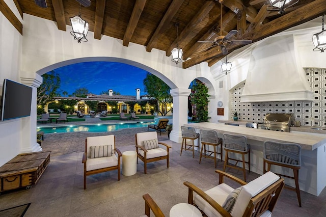 view of patio with exterior kitchen, grilling area, exterior bar, and ceiling fan