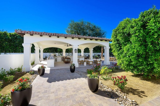 surrounding community with area for grilling, a gazebo, and a patio area