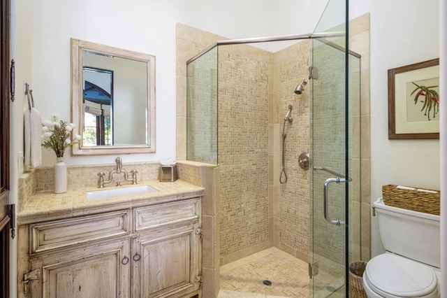 bathroom featuring vanity, toilet, and walk in shower