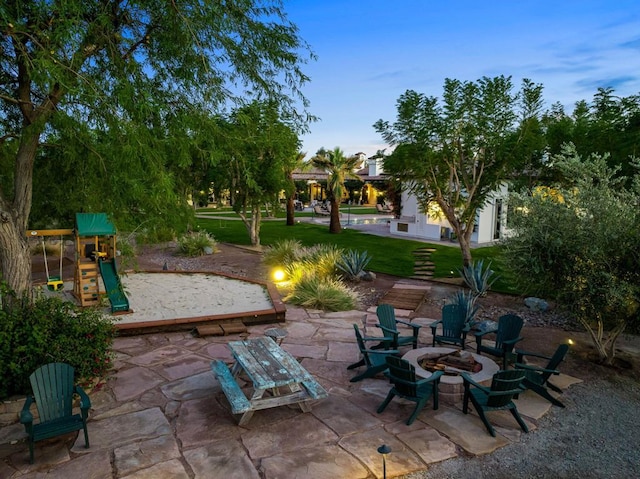 view of patio / terrace with a playground and an outdoor fire pit