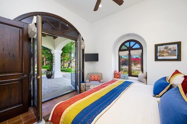 bedroom featuring light tile patterned flooring, ceiling fan, and access to exterior