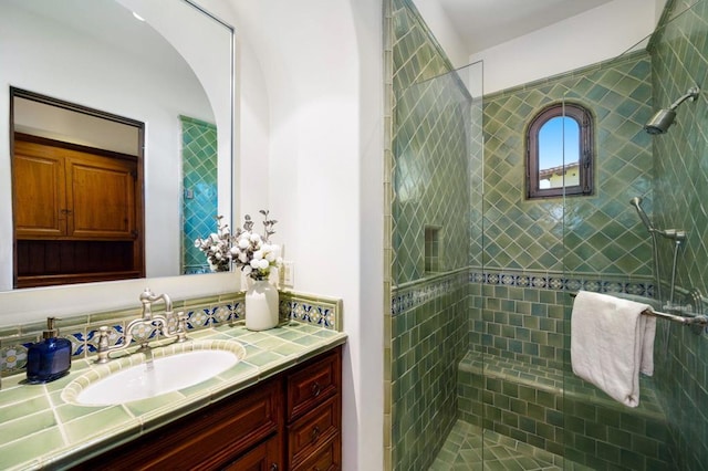 bathroom featuring vanity and tiled shower