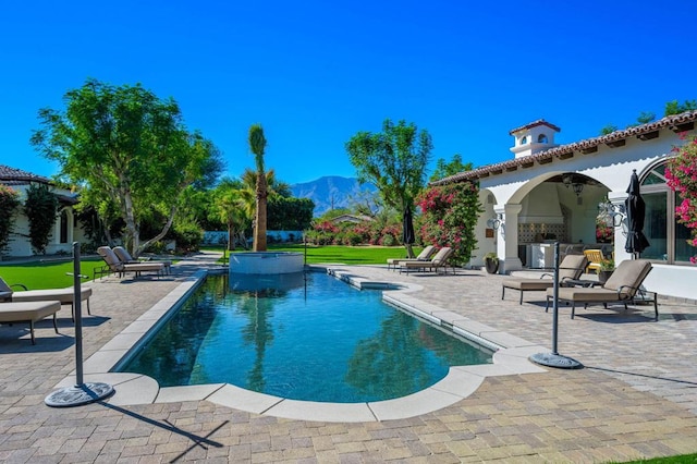 view of pool with a mountain view and a patio area