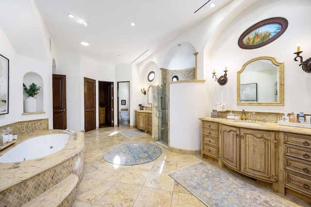 bathroom with walk in shower, vanity, and backsplash