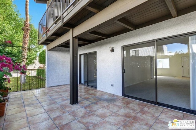 view of patio featuring a balcony