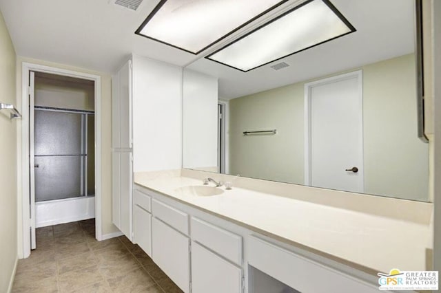 bathroom with shower / bath combination with glass door, tile patterned flooring, and vanity