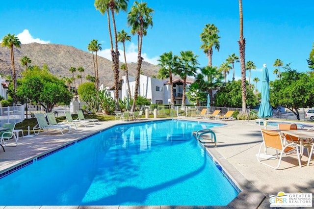 view of pool featuring a mountain view and a patio