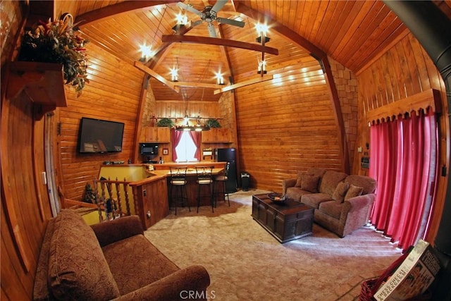 living room with wooden walls, beamed ceiling, and wood ceiling