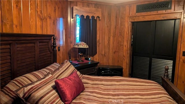 bedroom with wooden walls