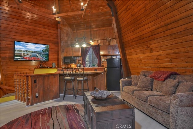 living room with carpet flooring, wood ceiling, wooden walls, high vaulted ceiling, and beamed ceiling